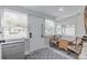 Charming entryway with wicker chairs, a gray storage cabinet and patterned rug at 415 21St N St, St Petersburg, FL 33713