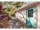Back exterior with teal shed door and brick patio at 415 21St N St, St Petersburg, FL 33713
