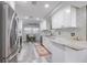 Renovated kitchen with white cabinets, granite counters, and stainless steel appliances at 415 21St N St, St Petersburg, FL 33713