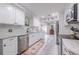 Renovated kitchen with white cabinets, granite counters, and stainless steel appliances at 415 21St N St, St Petersburg, FL 33713