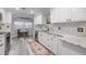 Renovated kitchen with white cabinets, granite counters, and stainless steel appliances at 415 21St N St, St Petersburg, FL 33713