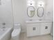 Bathroom with double vanity, toilet and marble tile shower at 4226 Elwood Rd, Spring Hill, FL 34609