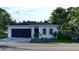 Modern house with dark brown garage door and white exterior at 4226 Elwood Rd, Spring Hill, FL 34609
