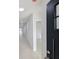 Bright hallway with light tiled floors and black door at 4226 Elwood Rd, Spring Hill, FL 34609