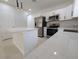 Modern kitchen with white cabinets, stainless steel appliances, and quartz countertops at 4226 Elwood Rd, Spring Hill, FL 34609