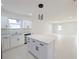 Modern kitchen with white cabinets, stainless steel appliances, and quartz countertops at 4226 Elwood Rd, Spring Hill, FL 34609
