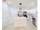 Modern kitchen with white cabinets, stainless steel appliances, and quartz countertops at 4226 Elwood Rd, Spring Hill, FL 34609