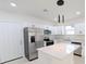 Modern kitchen with white cabinets, stainless steel appliances, and quartz countertops at 4226 Elwood Rd, Spring Hill, FL 34609