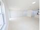 Open living room with tile floors and large windows at 4226 Elwood Rd, Spring Hill, FL 34609