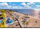 Aerial view of waterfront community with beach, parking, and gazebos at 4939 Floramar Ter # 501, New Port Richey, FL 34652