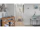 Bright hallway with tile flooring, coastal decor, and access to a bathroom at 4939 Floramar Ter # 501, New Port Richey, FL 34652