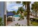 Community pool with surrounding lounge chairs and lush landscaping at 4939 Floramar Ter # 501, New Port Richey, FL 34652