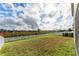 Backyard with green lawn and white fence at 529 Vista Ridge Dr, Ruskin, FL 33570