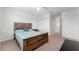 Spacious bedroom with wood frame bed, offering access to a hallway at 529 Vista Ridge Dr, Ruskin, FL 33570