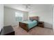 Bright bedroom with wood bed frame and teal bedding at 529 Vista Ridge Dr, Ruskin, FL 33570