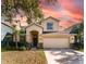 Two-story house with tan exterior, two car garage and landscaping at 529 Vista Ridge Dr, Ruskin, FL 33570