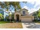 Two-story house with tan exterior, landscaping, and a two-car garage at 529 Vista Ridge Dr, Ruskin, FL 33570