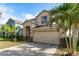 Two-story house with tan exterior, landscaping, and a two-car garage at 529 Vista Ridge Dr, Ruskin, FL 33570