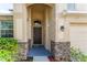 Front entrance with dark brown door and stone accents at 529 Vista Ridge Dr, Ruskin, FL 33570