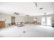 Spacious living room with kitchen undergoing renovations and exposed framing at 6951 S Shore S Dr, South Pasadena, FL 33707