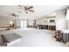 Large living room undergoing renovation, features exposed framing and new flooring at 6951 S Shore S Dr, South Pasadena, FL 33707