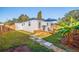 Backyard view showing deck, landscaping, and home at 826 53Rd N Ter, St Petersburg, FL 33703