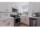Updated kitchen with white cabinets, quartz countertops, and stainless steel appliances at 826 53Rd N Ter, St Petersburg, FL 33703