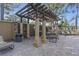 Brick patio with pergola, grill, and seating at 10199 Sailwinds S Blvd # I-102, Largo, FL 33773