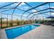 Serene screened-in pool with comfortable seating, clear skies, and ample space for outdoor relaxation and entertainment at 11312 Gallatin Trl, Parrish, FL 34219