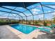 Inviting screened-in pool with clear blue water and comfortable lounge chairs set against a scenic outdoor backdrop at 11312 Gallatin Trl, Parrish, FL 34219