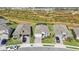 An aerial view of modern single-Gathering homes featuring manicured lawns and paved driveways in a sunny, Primary-planned community at 11312 Gallatin Trl, Parrish, FL 34219