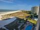 Aerial view of beach, pool, and surrounding buildings at 1270 Gulf Blvd # 1102, Clearwater Beach, FL 33767