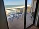 Spacious balcony overlooking the ocean with table and chairs at 1270 Gulf Blvd # 1102, Clearwater Beach, FL 33767