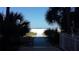 Walkway to beach with bench and tropical plants at 1270 Gulf Blvd # 1102, Clearwater Beach, FL 33767