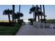 Brick walkway leading to the beach, shaded by palm trees at 1270 Gulf Blvd # 1102, Clearwater Beach, FL 33767