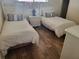 Well-lit bedroom with twin beds and wood flooring at 1270 Gulf Blvd # 1102, Clearwater Beach, FL 33767