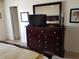 Bedroom with a large dresser and flat-screen TV at 1270 Gulf Blvd # 1102, Clearwater Beach, FL 33767