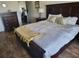 King-size bed in a well-lit bedroom with hardwood floors at 1270 Gulf Blvd # 1102, Clearwater Beach, FL 33767