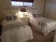 Twin bedroom with two beds and neutral decor at 1270 Gulf Blvd # 1102, Clearwater Beach, FL 33767