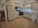 Full kitchen with white cabinets and appliances at 1270 Gulf Blvd # 1102, Clearwater Beach, FL 33767