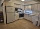Kitchen with white cabinets, stove, and refrigerator at 1270 Gulf Blvd # 1102, Clearwater Beach, FL 33767