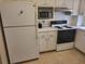 Kitchen with white appliances and ample counter space at 1270 Gulf Blvd # 1102, Clearwater Beach, FL 33767