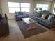Bright living room with sofas and a coffee table at 1270 Gulf Blvd # 1102, Clearwater Beach, FL 33767