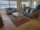 Bright living room with comfy sofas and a large window at 1270 Gulf Blvd # 1102, Clearwater Beach, FL 33767