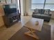 Living room featuring a TV stand and comfortable seating at 1270 Gulf Blvd # 1102, Clearwater Beach, FL 33767