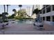 Community pool with lounge chairs and tables at 1270 Gulf Blvd # 1102, Clearwater Beach, FL 33767