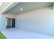 Covered back patio with sliding glass door and concrete flooring at 13419 Lake Monroe Pl, Riverview, FL 33579