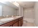 Bathroom with double vanity, mirror, and bathtub at 13419 Lake Monroe Pl, Riverview, FL 33579