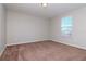 Spacious bedroom featuring carpet, window with blinds, and neutral walls at 13419 Lake Monroe Pl, Riverview, FL 33579