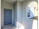 Front entry with blue door and arched window at 13419 Lake Monroe Pl, Riverview, FL 33579